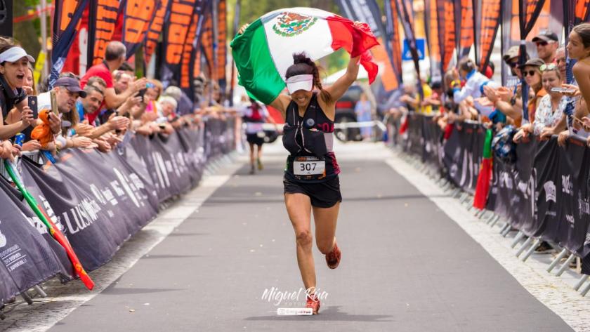 Mujer corriendo con la bandera de méxico 